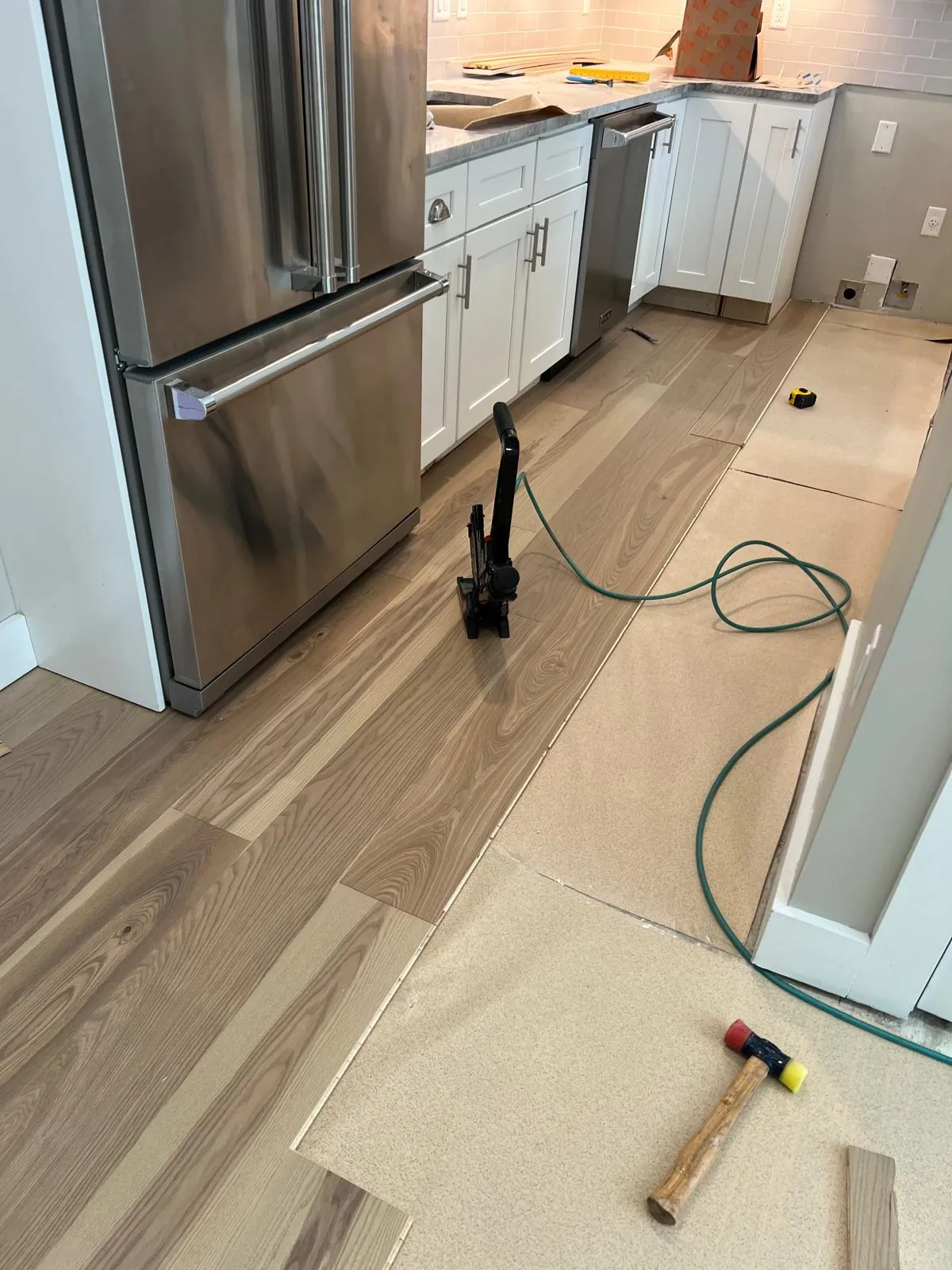 Colorstar installing hardwood flooring in a kitchen on the North Shore