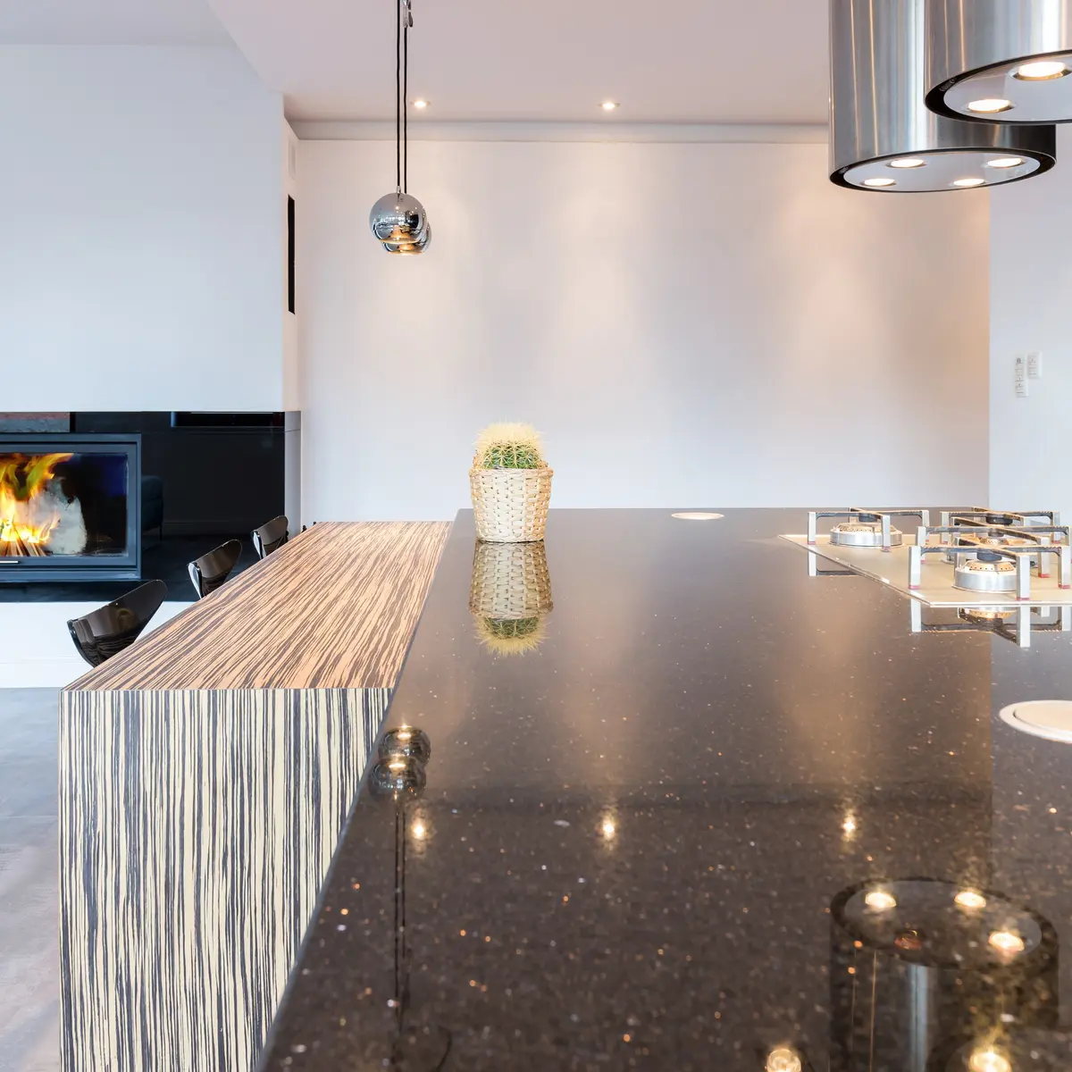 Open concept kitchen with quartz counter and range hood