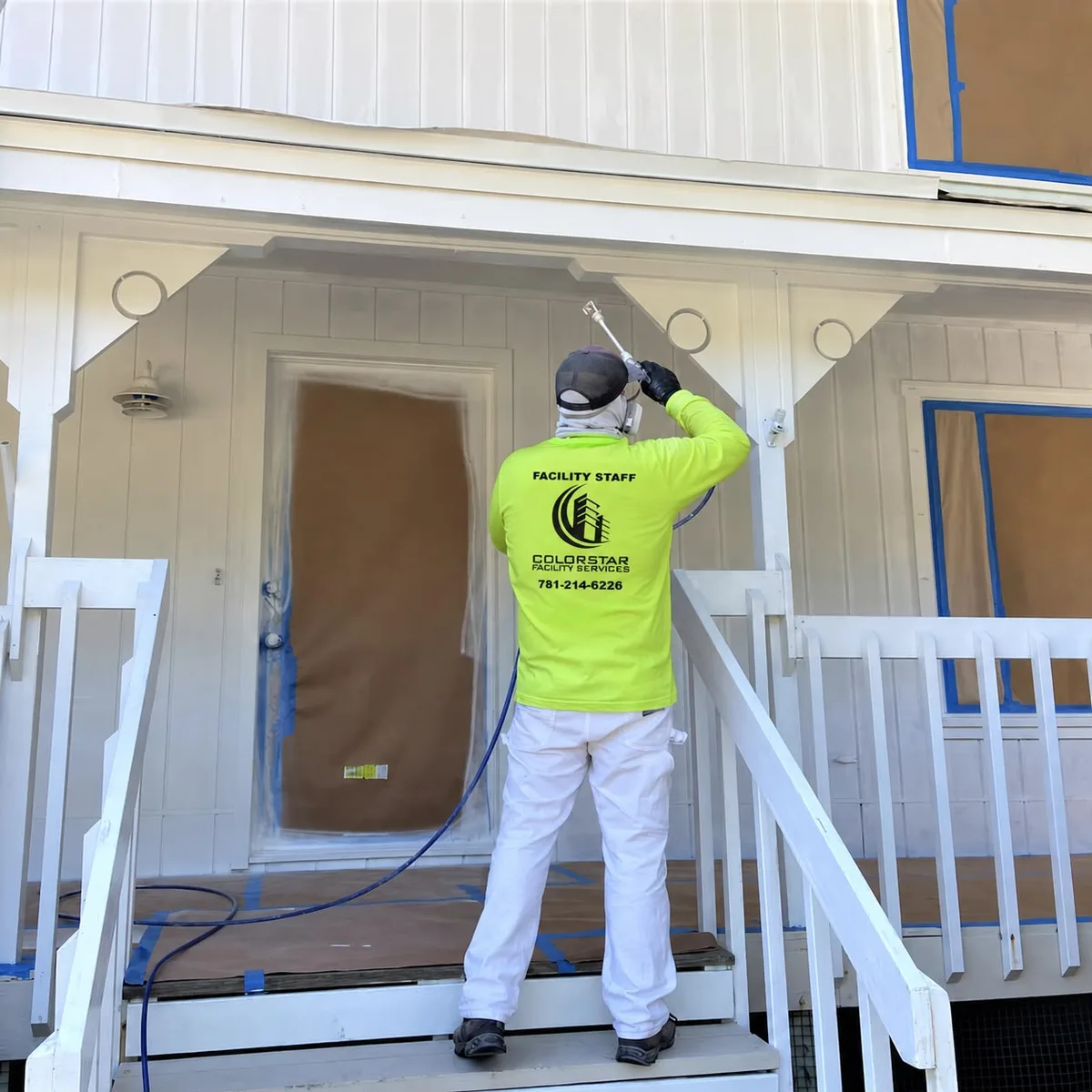 Painter prepping and painting the exterior of a North Shore home